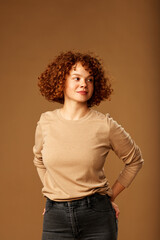 Portrait of a cute ginger girl with curly hair.