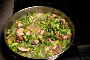 saute vegetales  in butter in pan