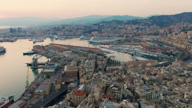 Panoramic Aerial view of Genoa Old Harbour with Aquarium, the Bigo and Biosfera. Typical Genova Landmark Skyline, Italy, Europe. Urban Travel and Architecture landscape. 4K zoom in drone shot