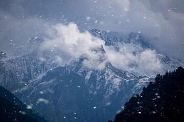 Snow covered mountain with clouds 