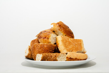 Turkish traditional bakery products on white plate: Simit, pogaca and acma.