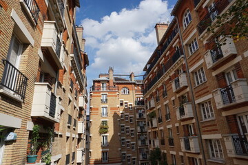 closeup of old stone and red bricks renovated buildings in downtown Paris, France