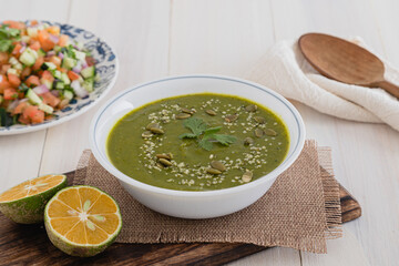 Green healthy spinach soup on wood board