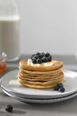 Pancakes with blue berries, ricotta and honey