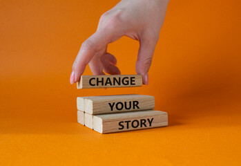 Change your story symbol. Concept word Change your story on wooden blocks. Beautiful orange background. Businessman hand. Business and Change your story concept. Copy space