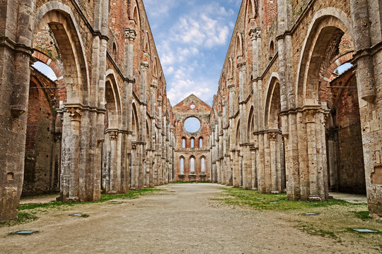 San Galgano abbey in Chiusdino, Siena, Tuscany, Italy. Roofless nave with colonnade of the medieval Gothic style church. It has been a location for films by Tarkovsky, Vadim and others