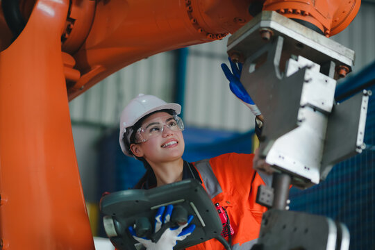 professional engineer,worker,technician use clipboard discuss work, walk in steel metal manufacture factory plant industry. Black African American man and woman wear hard hat check quality machine