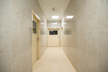 corridor in a hospital with manually closed door and LED lighting