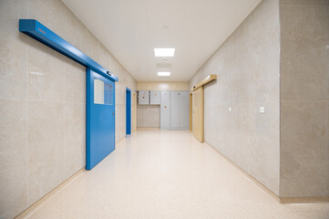 corridor in a hospital with electrical cabinets, LED lighting and automatic closed door