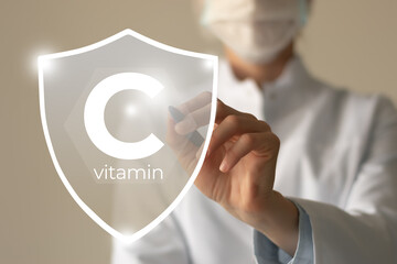 Immunity protection concept, vitamin C. Shield in doctor`s hands with Vitamin C.