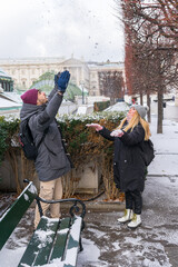 A bride and groom play in the snow