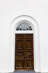 White building with brown door