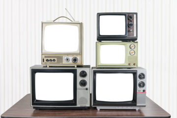 Five vintage televisions on old wood table with wall paper background and empty cut out screens. 