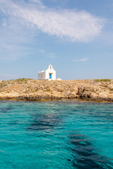 Tiny church with blue door on Island in Greece