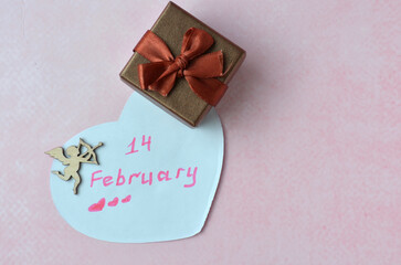 Valentine's day card and gift on pink background.