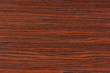 Rosewood texture. Texture of dark mahogany with an intense pattern, natural rosewood veneer for the production of furniture or yacht decoration
