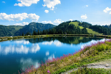 Fototapeta na wymiar Mountain lake on the Grafenberg hill in the Austrian Alps above the town of Wagrain.