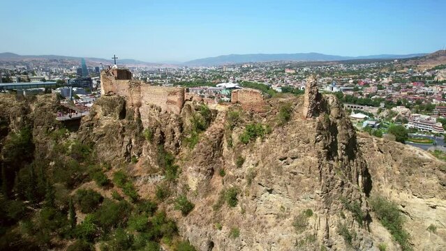 Drone view Narikala fortress in Tbilisi, capital of Georgia. famous tourist attraction in Tbilisi Old Town. Summer travel in Georgia, tourism destination.