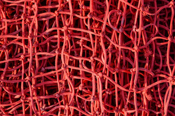 close-up of a red rope net. rope weave texture