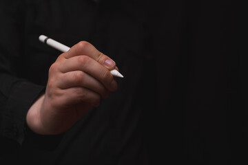 digital writing, hand holding digital pen, zero paper use, black background