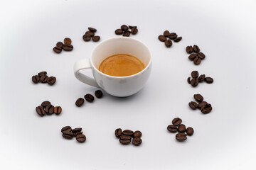 coffee beans form a clock with a steaming cup of coffee in the center, with a white background