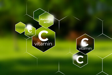 Immunity protection concept, vitamin C. Hexagons with Vitamin C name, blurry green background.