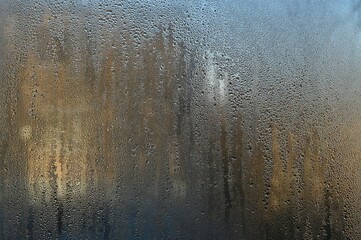 wet glass with textured water droplets on it