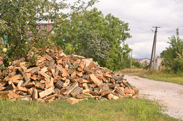 A pile of firewood is lying on the grass