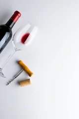 Fotobehang Bottle of red wine, glass and corkscrew on white background, with copy space © vectorfusionart