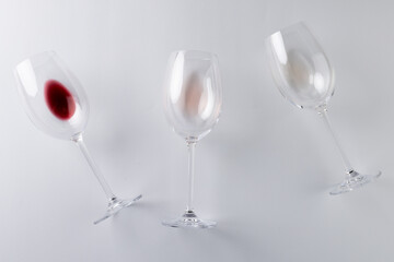 Glasses with red, rose and white wine on white background, with copy space