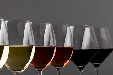  Glasses with red, rose and white wine on grey background, with copy space © vectorfusionart