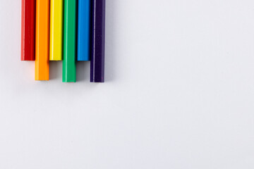 Close up of rainbow coloured pencils with copy space on white background
