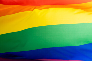 Close up of rainbow coloured flag with copy space