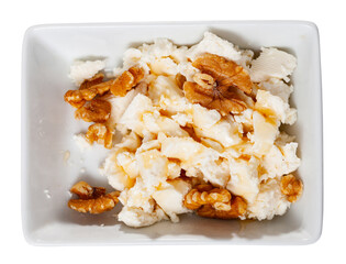 Portion of traditional Catalan dessert, mato with honey. Isolated over white background