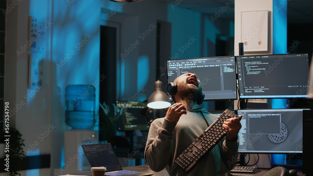 Poster careless html coder playing air guitar with keyboard, having fun and acting silly after hours. it en