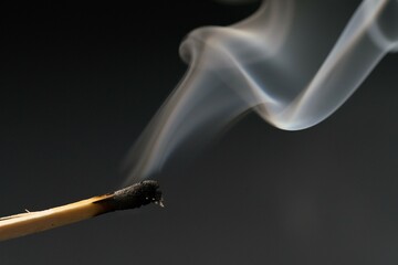 smoke from a match on a black background