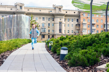 Obraz premium happy little boy running in the city park