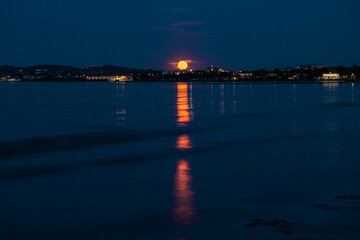 Super full moon rising over the beach in Sandymount, Dublin, Ireland