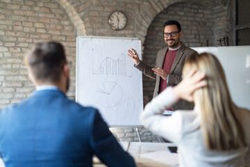 Businessman consulting employees at conference