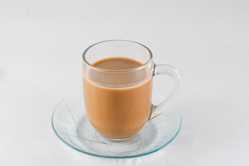 glass of cappuccino with a saucer isolated on a white background


