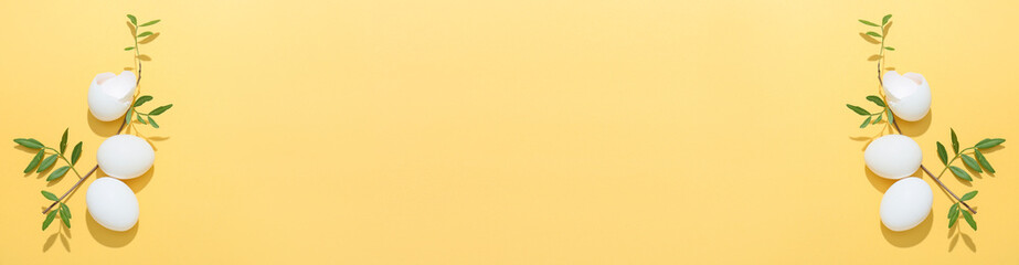 Banner with Easter eggs and leaves on beige background with space for text