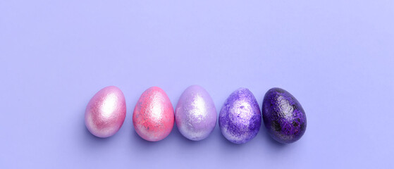 Beautiful Easter eggs on lilac background