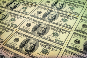 One hundred dollars. A lot of US dollars banknotes background. Hundred dollar bills.  Toned image