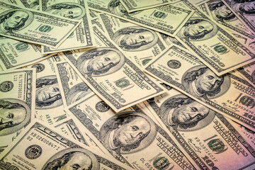 One hundred dollars. Bunch of money. US dollars banknotes background. Hundred dollar bills. American currency.  Toned image