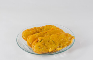 fried tempeh in a small plate on a white background
