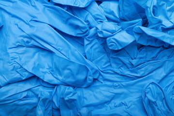 Blue medical gloves as background, closeup