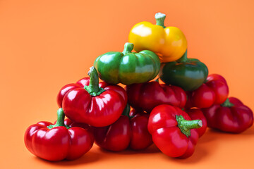 Heap of fresh bell peppers on color background