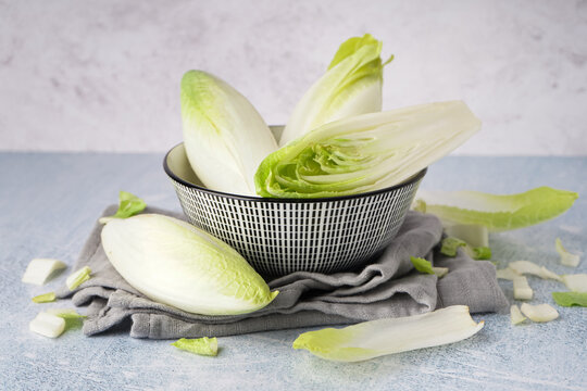 Bowl of fresh endive on light background