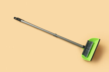 Cleaning broom with dustpan on color background