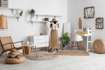 Interior of fashion designer's studio with mannequin, workplace and clothes